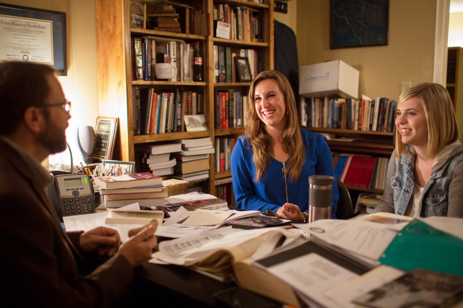 Students with history prof in his office