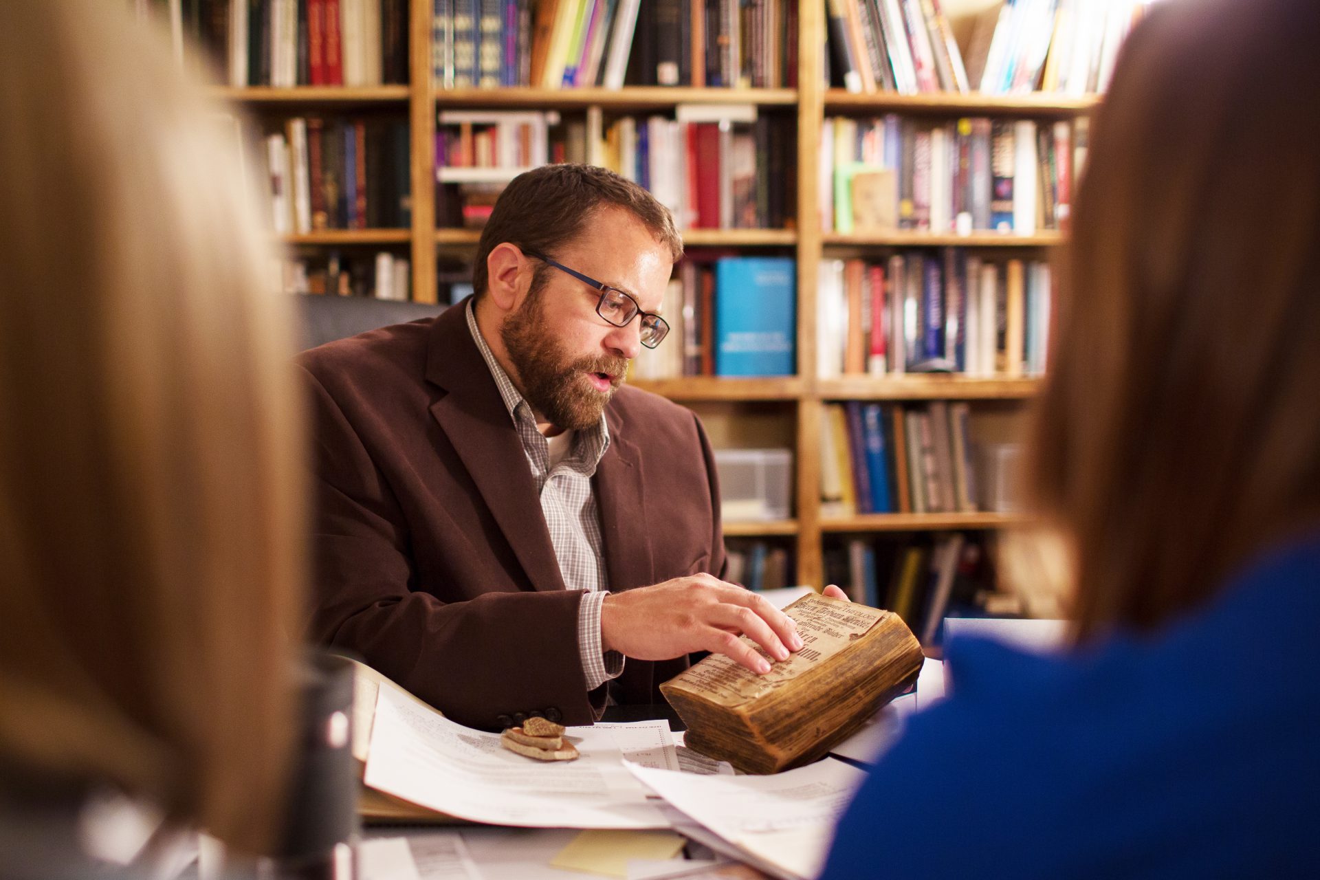 History prof with students and old book