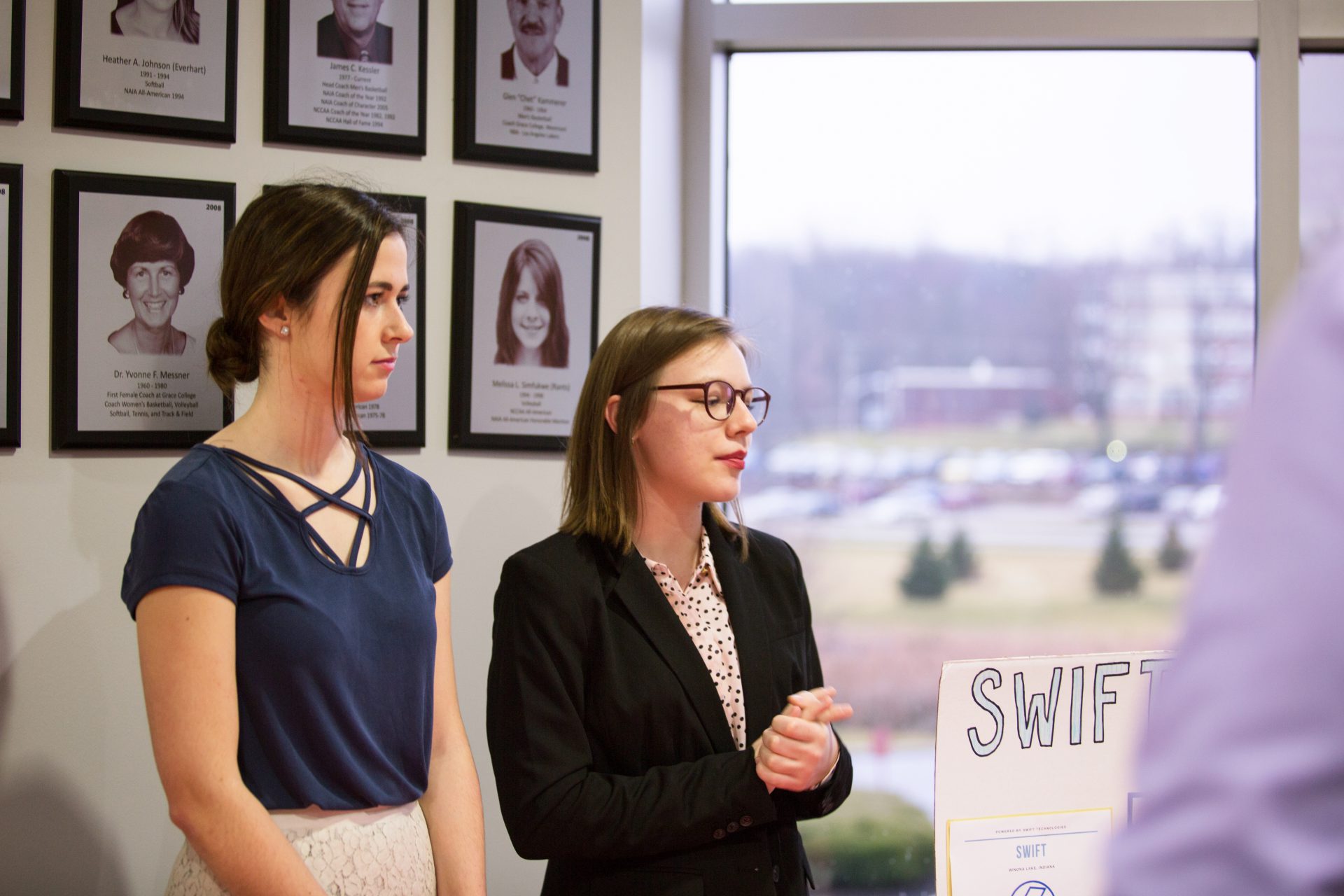 Business students presenting at table/booth