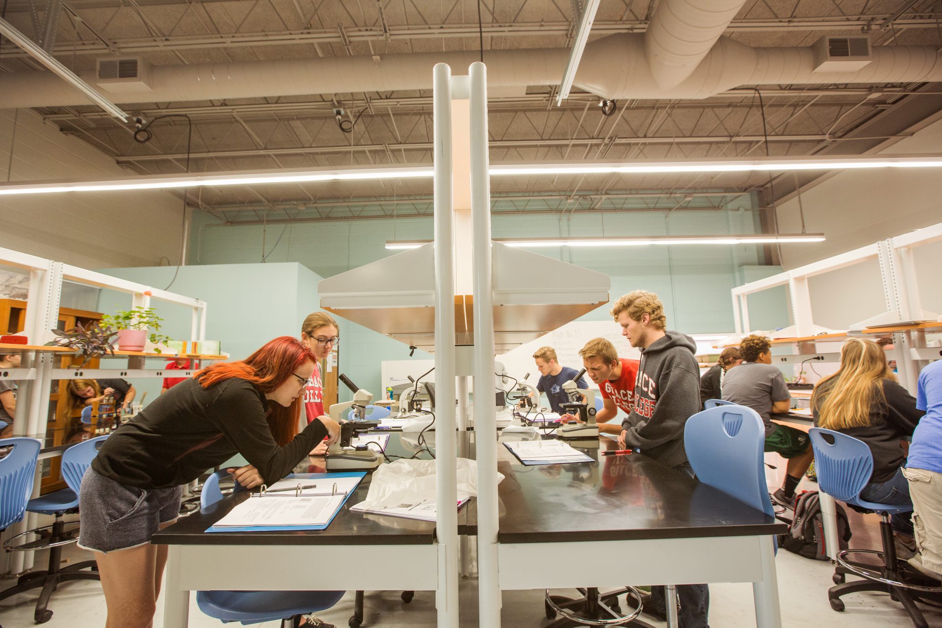 Students in chemistry lab with microscopes